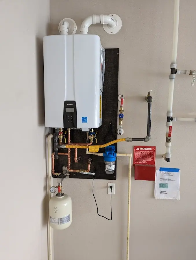 Professional plumber installing copper piping in a Gulfport home